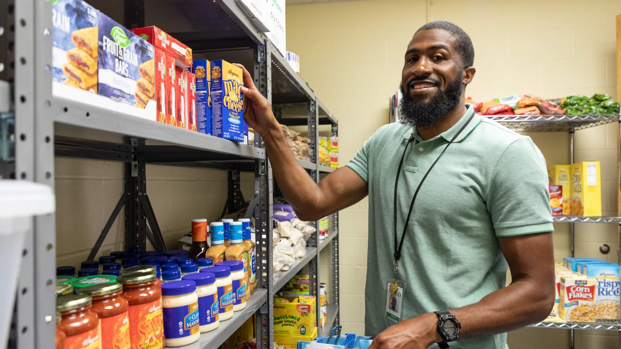 Man stocks school food pantry.